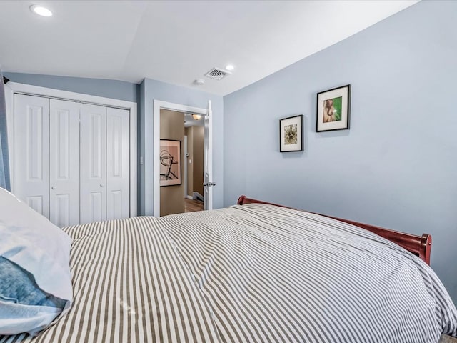 bedroom with a closet, visible vents, and recessed lighting