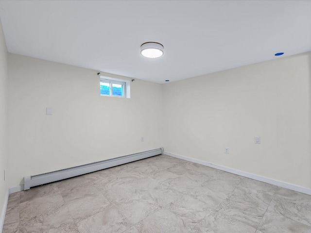 spare room featuring a baseboard radiator and baseboards