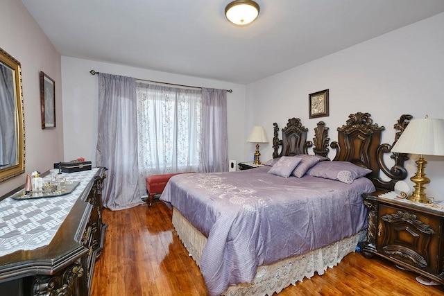 bedroom with wood finished floors