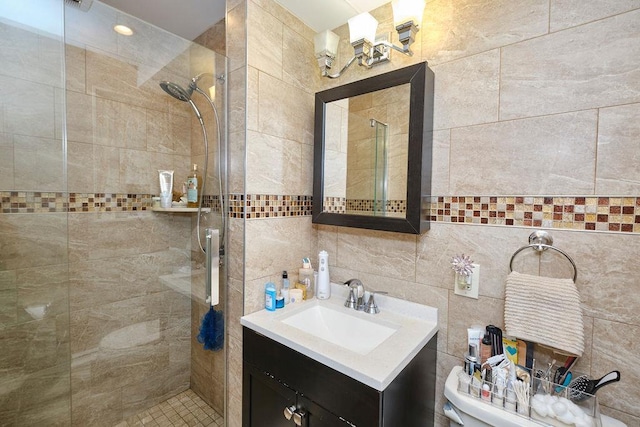 bathroom with decorative backsplash, tiled shower, toilet, vanity, and tile walls