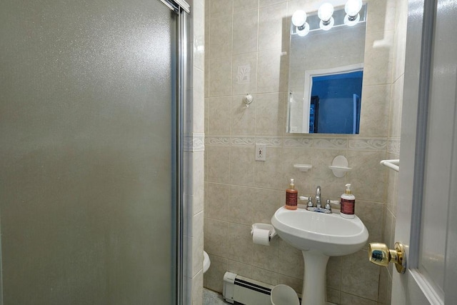 full bathroom with a baseboard heating unit, tile walls, and a shower stall