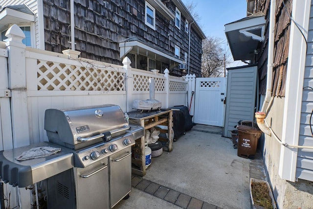 view of patio featuring a gate, fence, and area for grilling