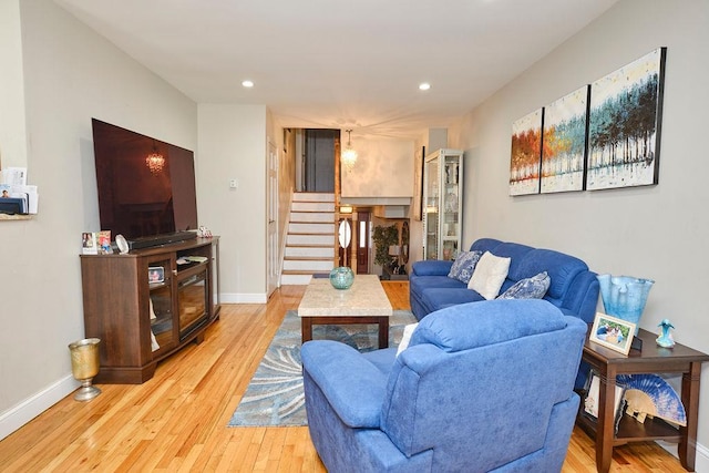 living room with stairway, recessed lighting, light wood-style flooring, and baseboards