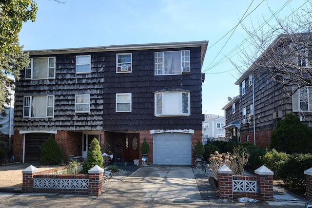 view of front of house featuring brick siding, driveway, and an attached garage