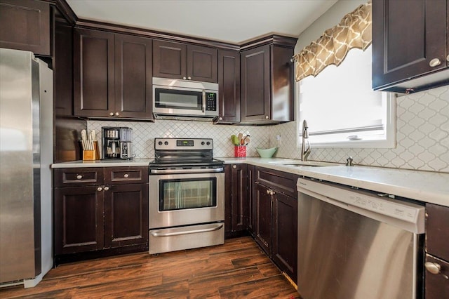 kitchen featuring stainless steel appliances, dark wood-type flooring, dark brown cabinetry, and tasteful backsplash