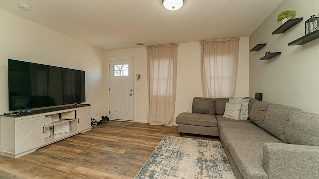 living area with visible vents and dark wood-style flooring