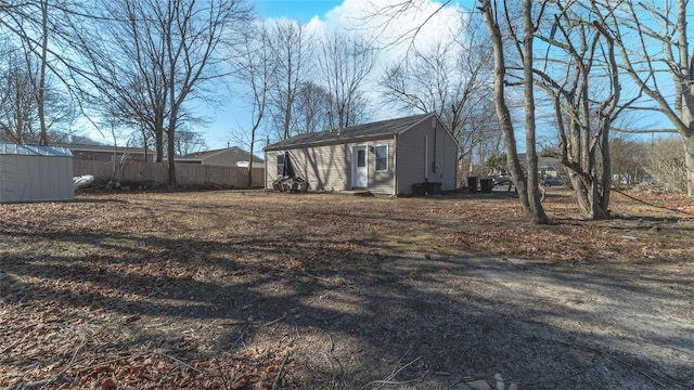 view of yard with fence and an outdoor structure