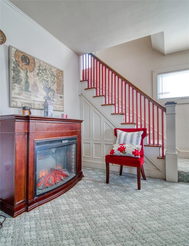 interior space with stairway, carpet, and a glass covered fireplace