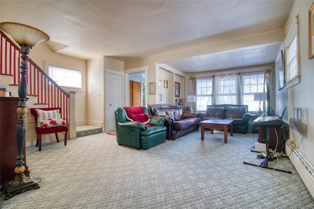 carpeted living room featuring stairs and plenty of natural light