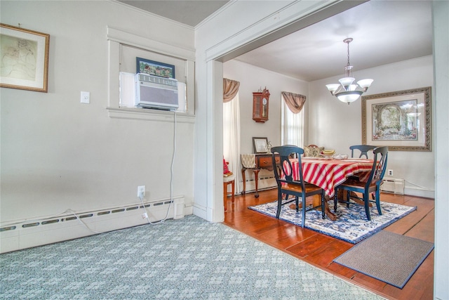 dining area with a chandelier, a baseboard radiator, a baseboard heating unit, wood finished floors, and ornamental molding