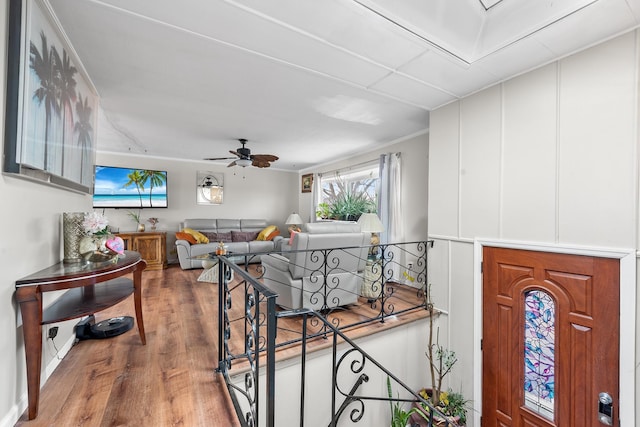 interior space with a ceiling fan and wood finished floors