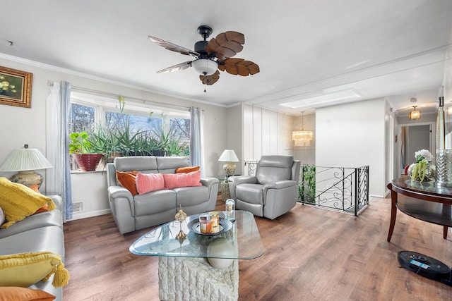 living room with visible vents, ornamental molding, ceiling fan, wood finished floors, and baseboards