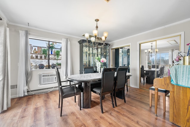 dining space with a chandelier, a baseboard heating unit, ornamental molding, and a wall unit AC