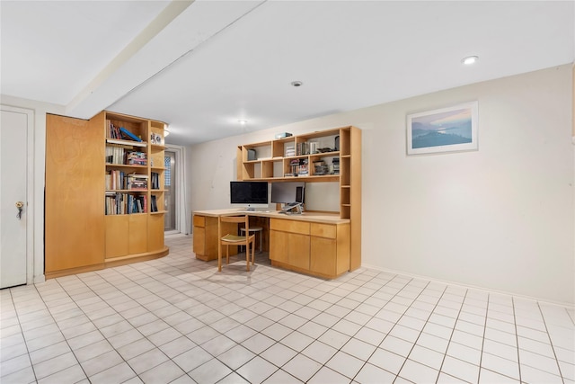 home office featuring baseboards, built in desk, and beamed ceiling