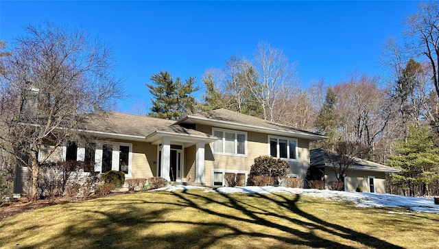 split level home featuring a front lawn