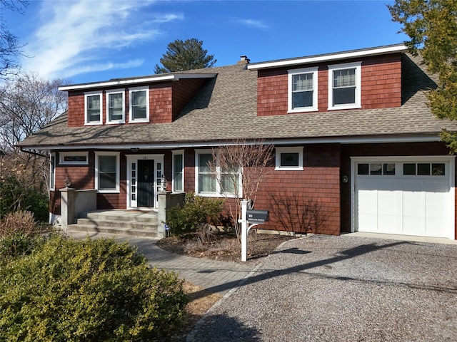 view of front of property with a garage, driveway, a shingled roof, and covered porch