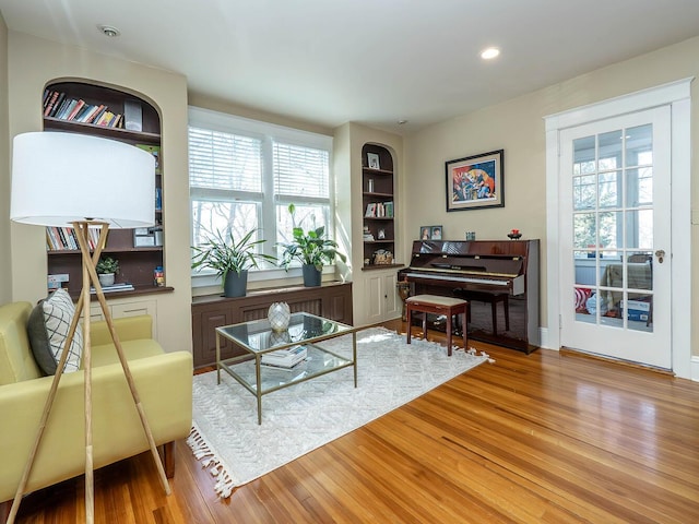 living area featuring wood finished floors and recessed lighting