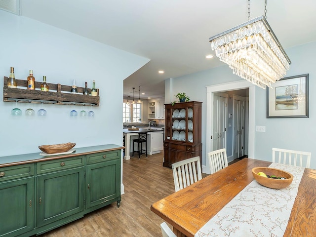 dining area with light wood-style floors, visible vents, and recessed lighting