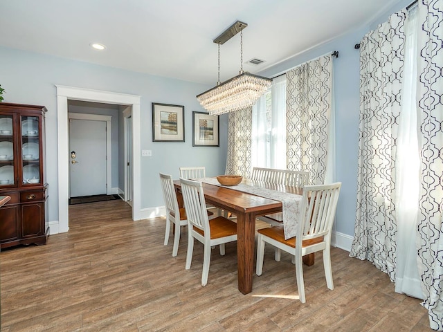 dining space with recessed lighting, wood finished floors, and baseboards