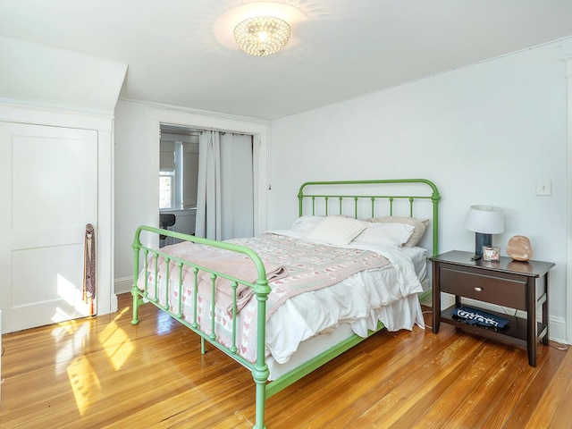 bedroom with light wood-style flooring and baseboards