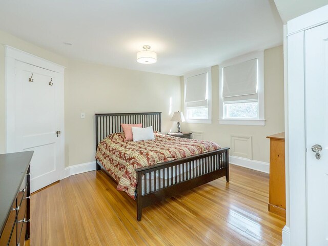 bedroom featuring light wood-style floors and baseboards