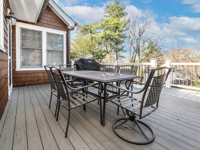 wooden deck with grilling area and outdoor dining area