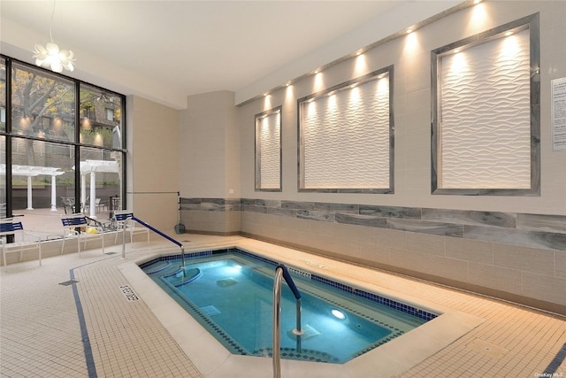 view of pool with a pool and an indoor hot tub