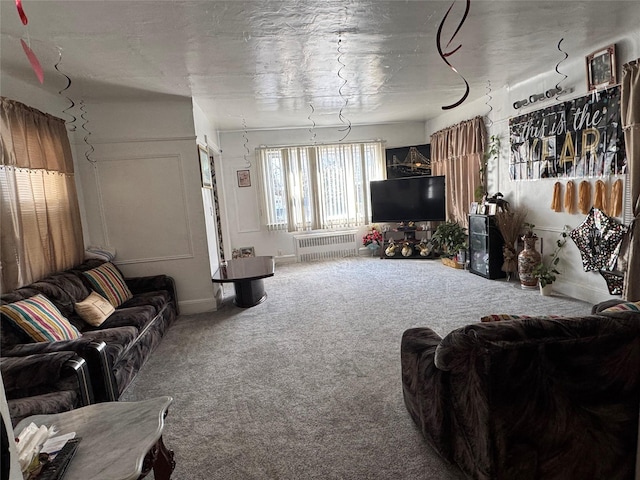 living area with radiator and carpet