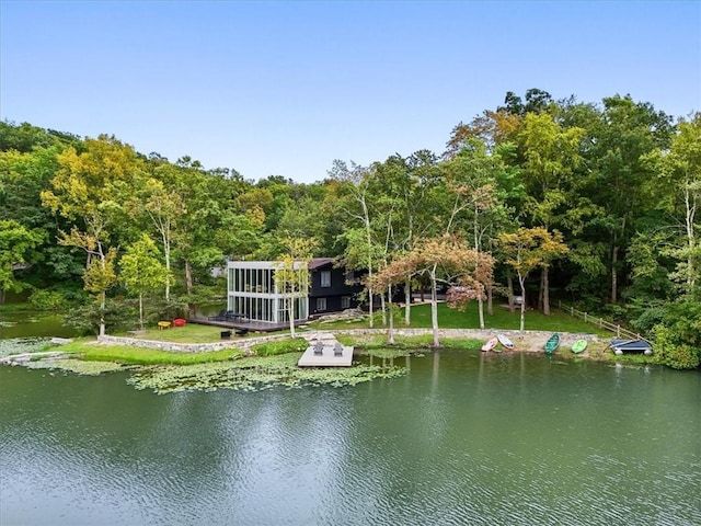 view of water feature with a boat dock and a view of trees