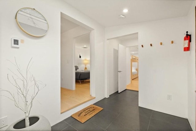 corridor featuring dark tile patterned flooring