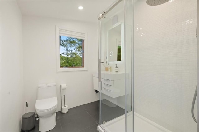 bathroom with a stall shower, toilet, tile patterned floors, vanity, and recessed lighting