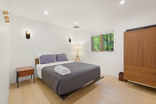 bedroom with recessed lighting, visible vents, and light wood-style floors