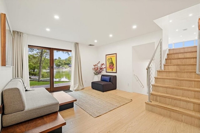 living area featuring french doors, stairway, wood finished floors, and recessed lighting