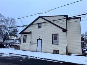 view of snow covered rear of property