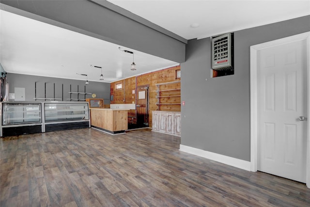 interior space with dark wood-style floors, baseboards, and open floor plan