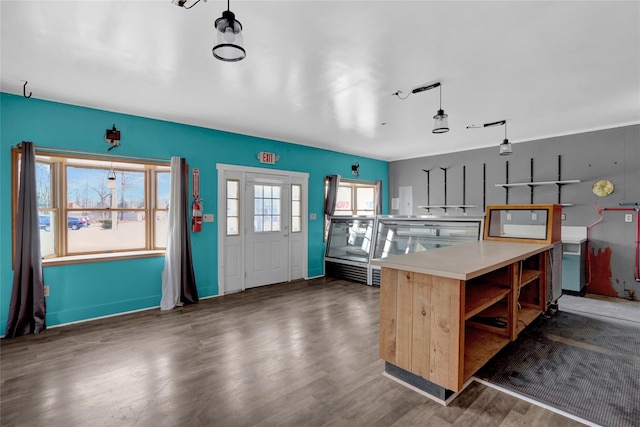 kitchen with wood finished floors, light countertops, and open shelves