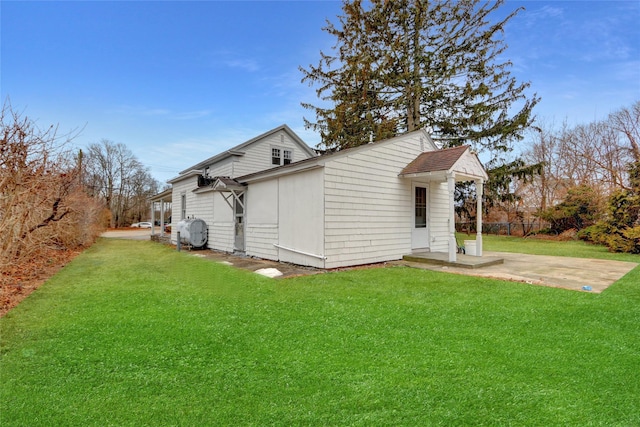 view of side of home featuring a lawn