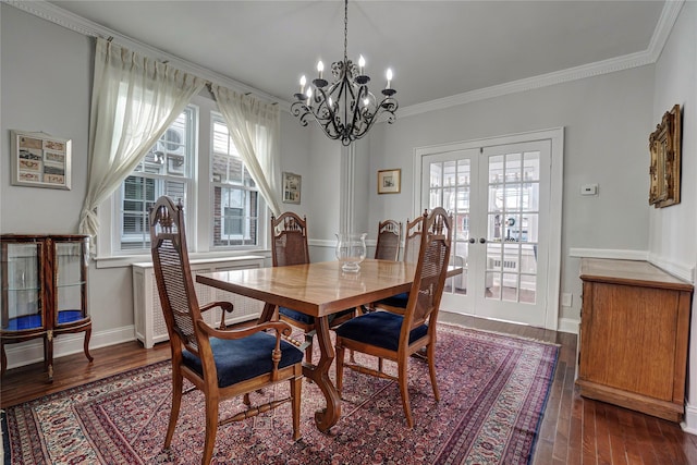 dining area featuring ornamental molding, french doors, wood finished floors, and baseboards