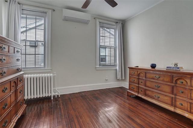 interior space with dark wood-style flooring, radiator heating unit, a wall mounted AC, ceiling fan, and baseboards