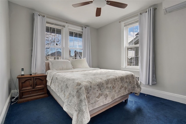 bedroom featuring ceiling fan, baseboards, dark colored carpet, and a wall mounted AC