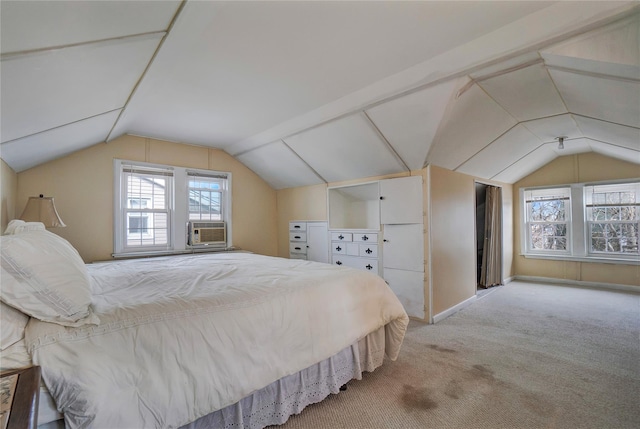 carpeted bedroom featuring cooling unit, vaulted ceiling, and baseboards