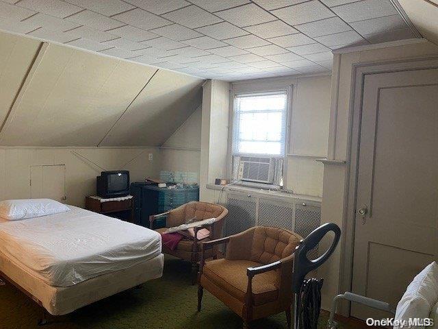 bedroom featuring cooling unit and vaulted ceiling