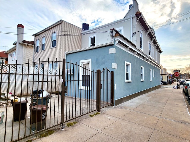 exterior space featuring a fenced front yard and stucco siding