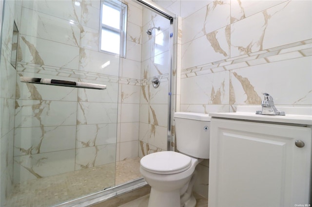 full bath featuring tile walls, a shower stall, toilet, and vanity