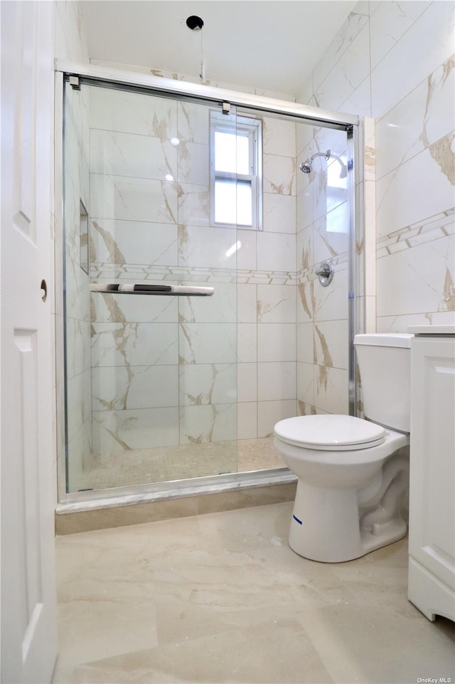 full bath featuring a marble finish shower and toilet