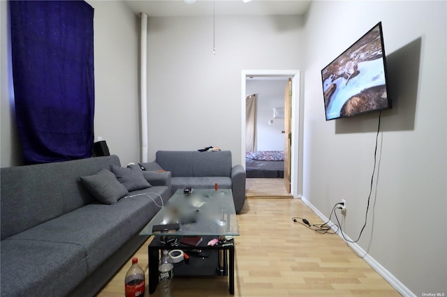 living area with wood finished floors and baseboards