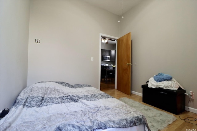 bedroom featuring baseboards and light wood finished floors