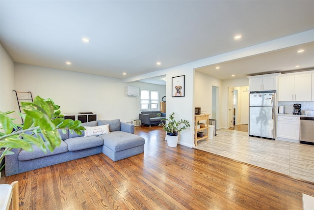 living room with light wood-type flooring, baseboards, and recessed lighting