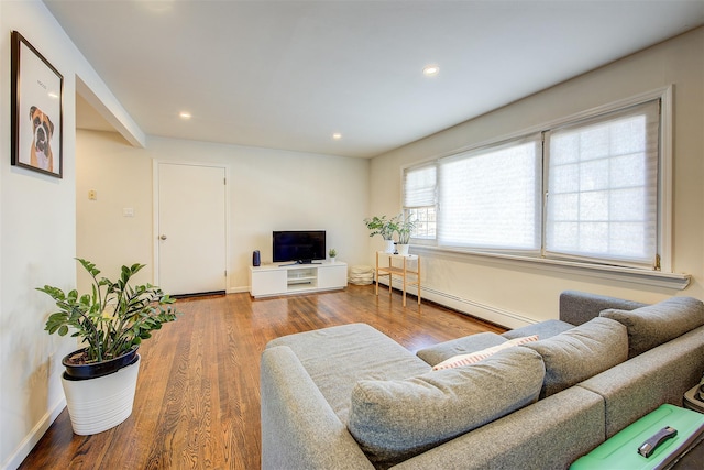 living area with a baseboard radiator, baseboards, recessed lighting, and wood finished floors