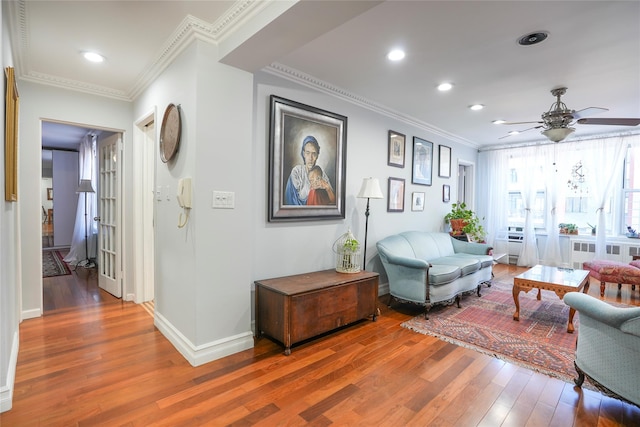 interior space with ornamental molding, recessed lighting, baseboards, and wood finished floors